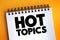 Hot Topics text on notepad, concept background