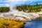 Hot water from the Oblong Geyser flowing into the Firehole River in Yellowstone National Park