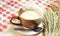 Hot white malt on a table covered with plaid cloth