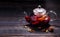 Hot wine mulled wine with spices in a glass teapot on a wooden table and space for text.