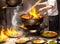 A hot wok with chef in a Chinese kitchen. back view of the chef, Chinese food being cooked in a wok on fire in the Chinese kitchen