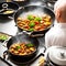 A hot wok with chef in a Chinese kitchen. back view of the chef, Chinese food being cooked in a wok on fire in the Chinese kitchen