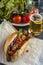 Hotdog with sausage and vegetables and glass of beer