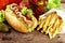 Hotdogs ready-to-eat with fresh salad on wooden desk