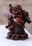 Hotei - chinese god of wealth, prosperity and happiness seating in the rocking-chair. Ancient figurine.