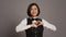 Hotel administrator shows heart shape symbol on camera