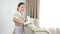 Hotel and apartment cleaning. Soft furniture surface being cleaned by pretty maid with wipe in hands. woman removing