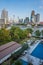 Hotel backyard with pool, sundeck and city view. View from above