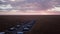 Hotel, bungalow or residential buildings in the savannah field in Africa sunset.