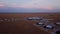 Hotel, bungalow or residential buildings in the savannah field in Africa sunset.