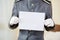 Hotel clerk holding empty white paper