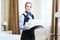 Hotel female housekeeping worker with linen