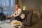 Hotel guest pouring tea into cup in her room