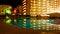 Hotel with illuminated swimming pool at night