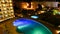 Hotel with illuminated swimming pool at night