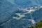 Hotel in the mountains among the green forest. Serpentine road in the mountains. Krasnaya Polyana, Sochi, Russia