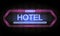 Hotel neon sign on brick wall