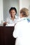 Hotel receptionist, hospitality and a black woman helping a senior tourist to check in at a luxury resort. Concierge