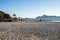 Hotel on sandy seashore at beach against clear blue sky during summer