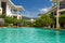 Hotel with sky-blue swimming pool with palm trees