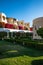 Hotel suites exterior with palms, garden and blue sky