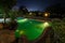 Hotel swimming pool lit at night