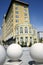 Hotel with three large sphere sculptures in foreground