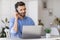 Hotline Operator. Portrait Of Call-Center Employee Wearing Headset At Workplace In Office