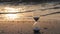 Hourglass on the beach in golden morning light