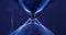 Hourglass on blue colored background