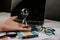 Hourglass in a businessman hand, laptop and magnifier on desk