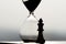 Hourglass and chess, time accumulation and career success
