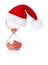 Hourglass with Christmas Santa hat showing the passage of time