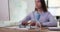 Hourglass closeup with employee human hands typing on computer