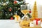 Hourglass, gifts and festive decor on table. Christmas countdown