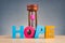 Hourglass and HOPE word made from wooden letter on desk