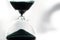 An hourglass measuring the passing time in a countdown to a deadline