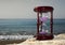 Hourglass on sandy marine beach