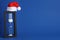 Hourglass and Santa hat on blue, space for text. Christmas countdown