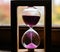 Hourglass in a wooden frame with pink sand