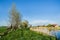 House above the river, trees and blue sky. Beautiful spring landscape in Poland