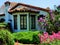 House Adobe style with beautiful landscape of cacti and other blooming flowers