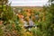 House amon colourful trees in a forested landscape in autumn