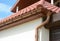 House attic metal roof with soffits, fascias, roof guttering, downspout gutter pipe.