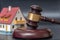 House auction concept. Gavel in front of a house model