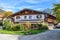 House with a balcony and decoration on a background of mountains in Alps