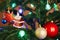 House, balls, stars and lighting garland on Christmas tree