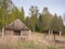 House with a barn standing on the field