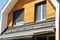 House Blinds Sun Protection Exterior with Solar Panels. Windows in New Modern Passive House Attic Facade Wooden Wall with Shutters