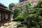 house, blooming flowers and river reflecting in onsen town, Yufuin, Oita, Kyushu
